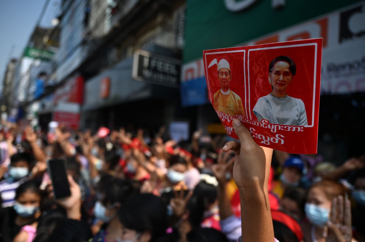 A protester holds up a sign with the images of detained Myanmar civilian leader Aung San Suu Kyi (R) and president Win Myint during a demonstration against the military coup in Yangon on Saturday. (AFP-Yonhap)