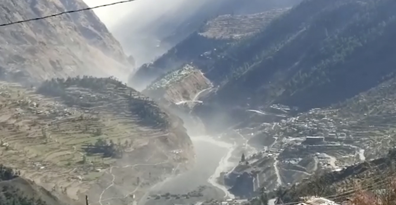 This frame grab from video provided by KK Productions shows a massive flood of water, mud and debris flowing at Chamoli District after a portion of Nanda Devi glacier broke off in Tapovan area of the northern state of Uttarakhand, India, Sunday. (KK Productions)