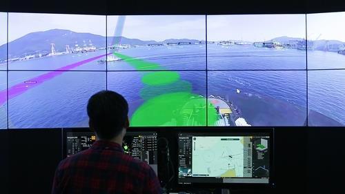 This file photo, provided by Samsung Heavy Industries Co. on Oct. 19, 2020, shows a person controlling the company's remote autonomous ship in seas off Geoje Island via a remote control system at a research center in Daejeon, 250 kilometers away from the seas. (Samsung Heavy Industries Co.)