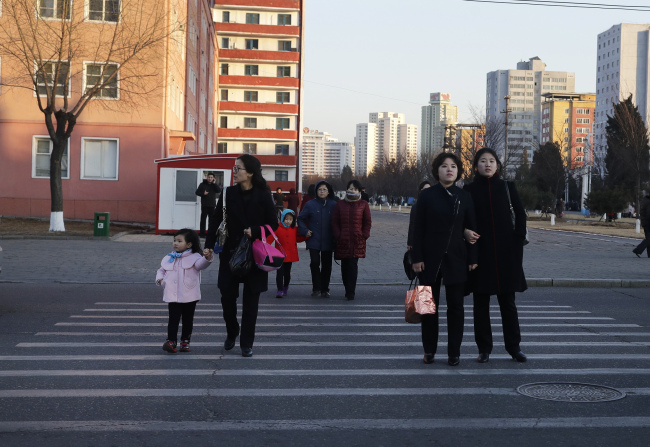 Women walk through the streets of downtown Pyongyang, North Korea. (AP-Yonhap)