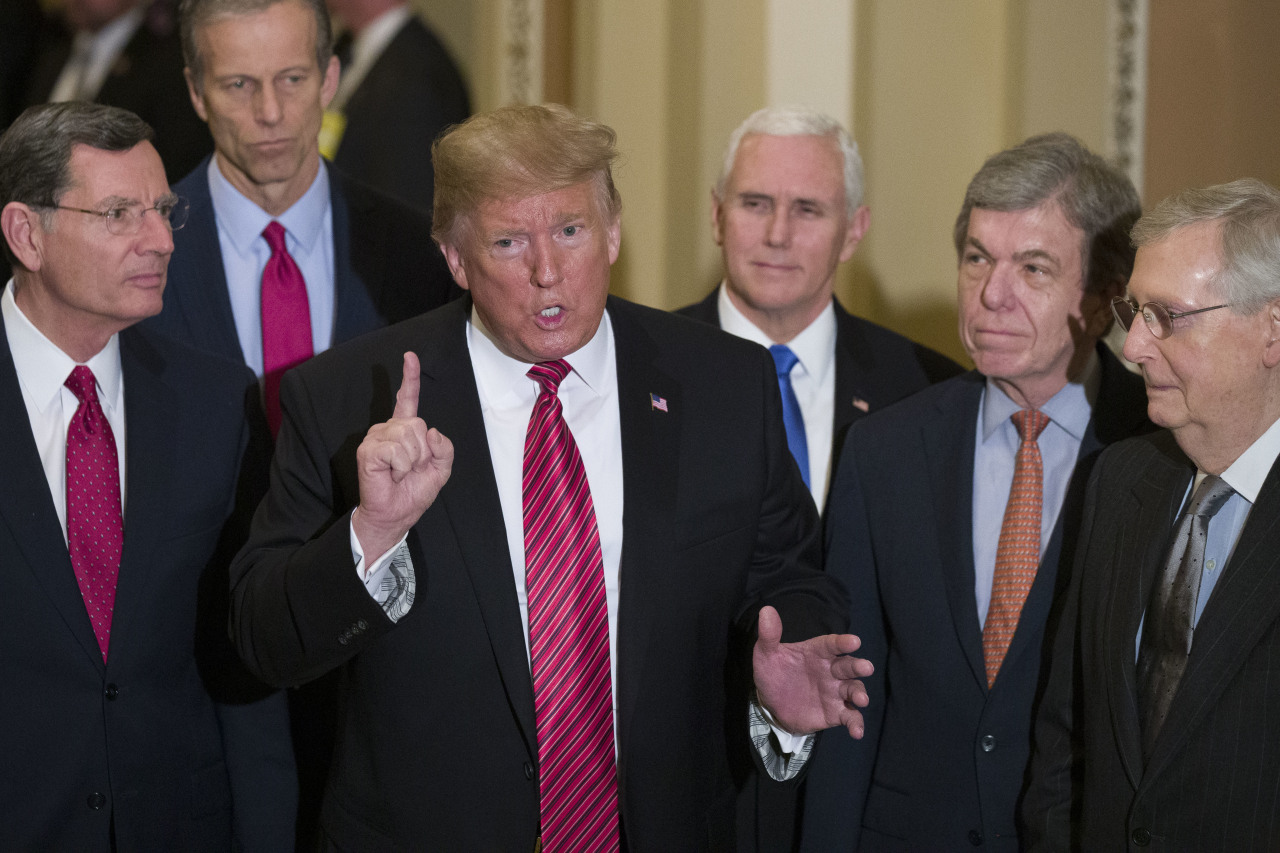 In this Jan. 9, 2019 file photo, Sen. John Barrasso, R-Wyo., left, and Sen. John Thune, R-S.D., stand with President Donald Trump, Vice President Mike Pence, Sen. Roy Blunt, R-Mo., and Senate Majority Leader Mitch McConnell of Ky., as Trump speaks while departing after a Senate Republican Policy luncheon, on Capitol Hill in Washington. (AP-Yonhap)