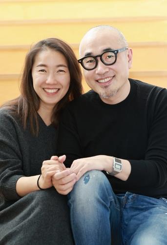 This image, provided by Woowa Brothers Corp. on Thursday, shows CEO Kim Bong-min (R) and his wife Sul Bomi. (Woowa Brothers Corp.)