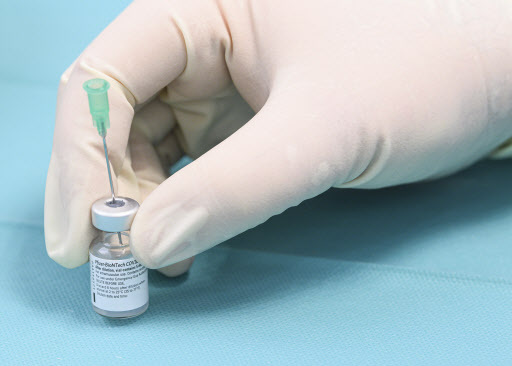 A helper prepares vaccine against Covid-19 from Biontech/Pfizer for a vaccination in a so-called 