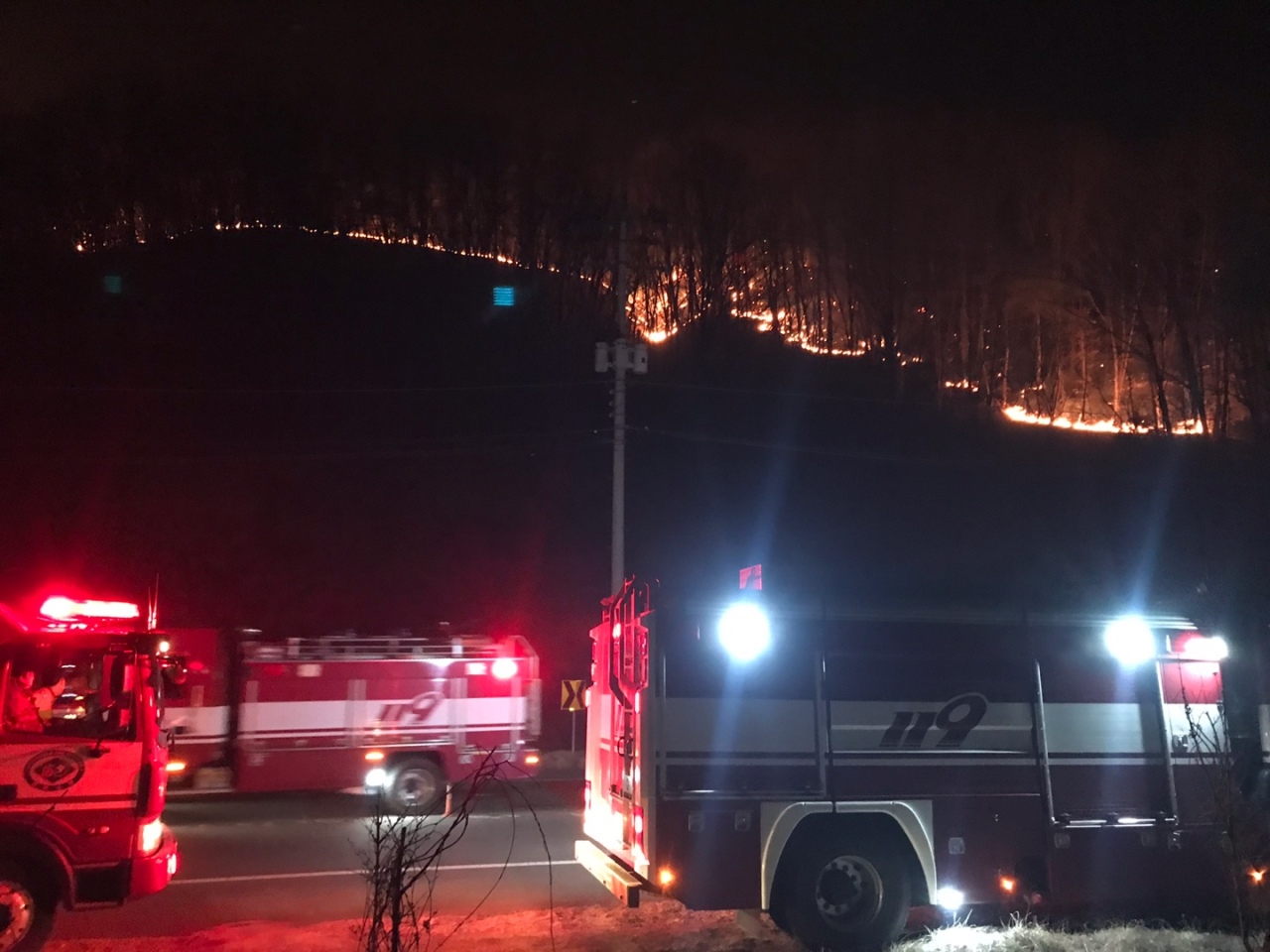 Firefighters work to contain a wildfire in Andong, North Gyeongsang Province, on Sunday, in this photo provided by the National Fire Agency. (National Fire Agency)