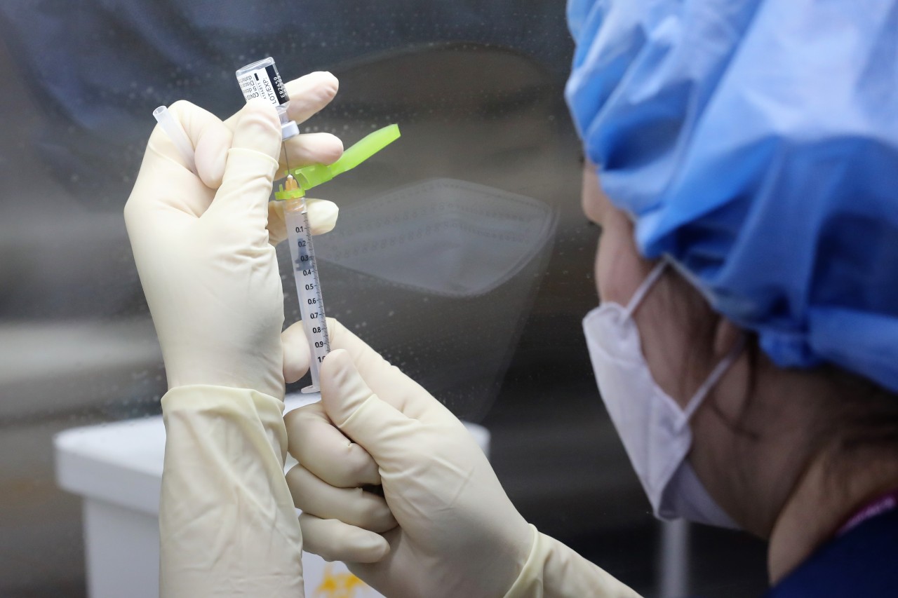 A health worker prepares a Pfizer COVID-19 vaccine at a hospital in central Seoul on Saturday. (Yonhap)