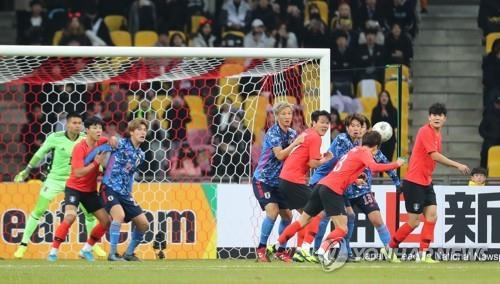 In this file photo from Dec. 18, 2019, South Korea (in red tops) and Japan are in action in the final of the East Asian Football Federation E-1 Football Championship at Busan Asiad Main Stadium in Busan. (Yonhap)
