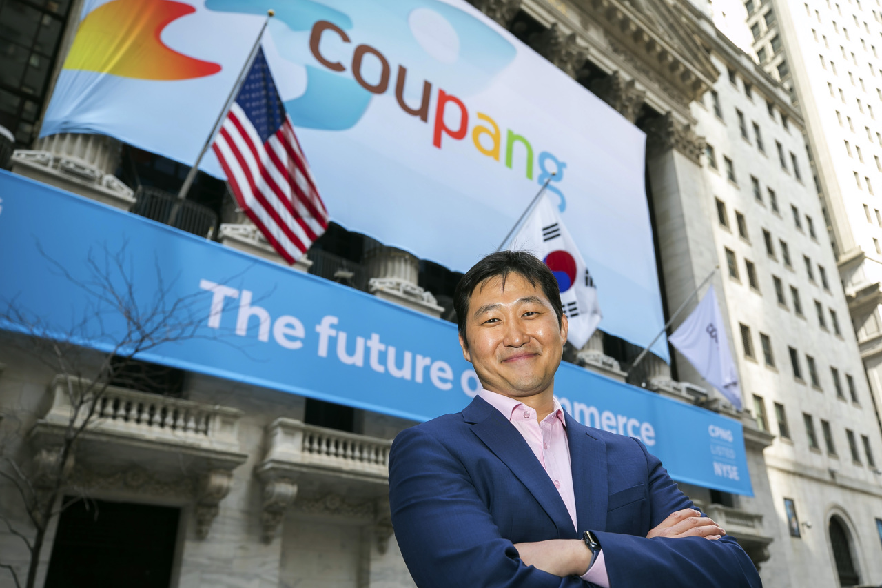 Coupang founder Kim Bom-suk poses in front of the New York Stock Exchange on March 11. (Yonhap)