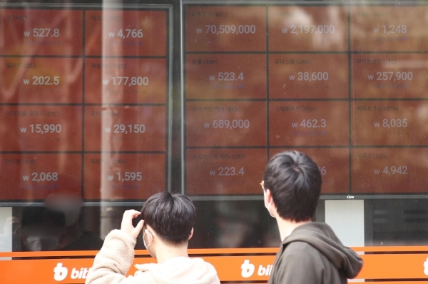 Digital screens in the windows of a Bithub center in Seoul show the price of Bitcoin above 70 million won ($61,976) on March 14. (Yonhap)