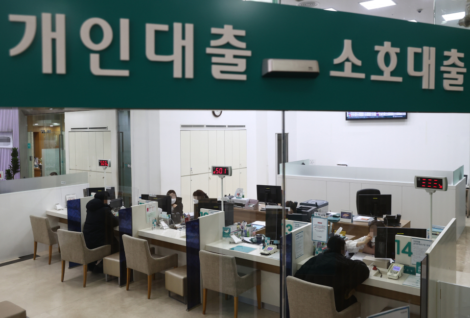 This file photo, taken on Jan. 5, 2021, shows customers consulting about loan products at a bank in Seoul. (Yonhap)