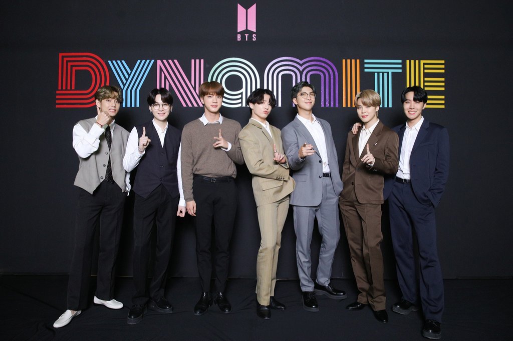 This Sept. 2, 2020, photo, provided by Big Hit Entertainment, shows BTS members posing for photos during an online media day event held in Seoul to showcase the release of 