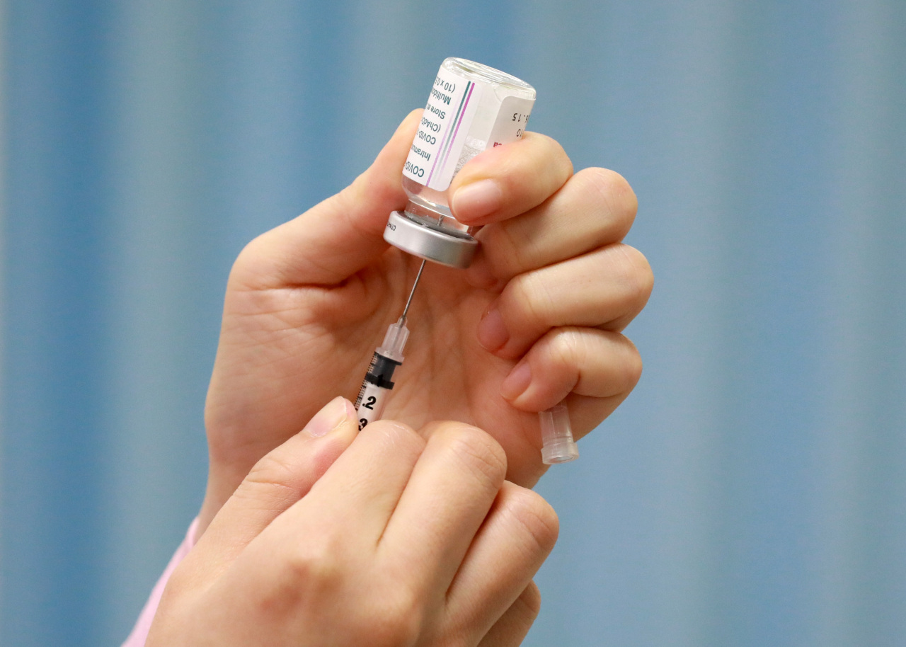 A medical worker fills a syringe with a coronavirus vaccine at a public health center in western Seoul on Friday. (Yonhap)