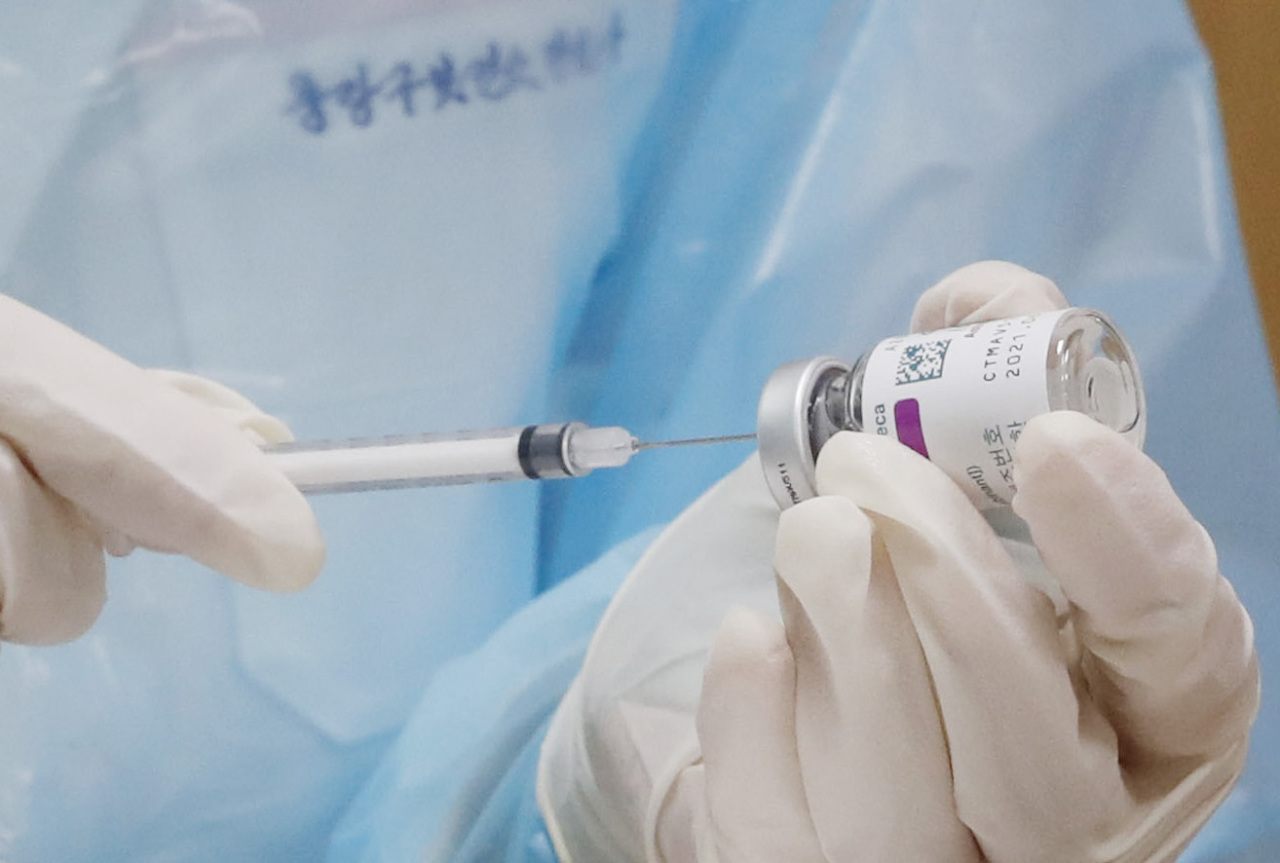 A health care worker in Seoul prepares an AstraZeneca vaccine dose for inoculation. (Yonhap)