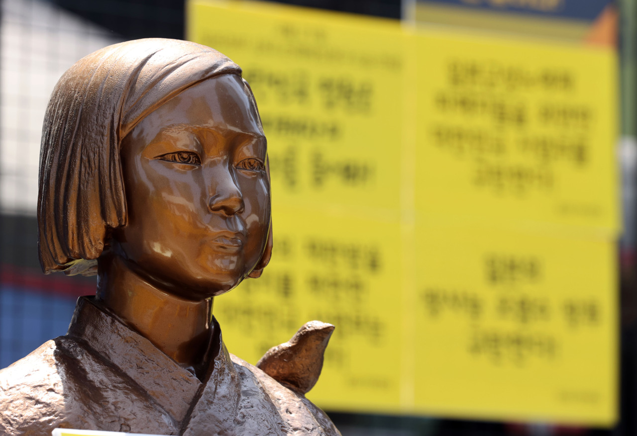 A statue memorializing the comfort women near the Japanese Embassy in Seoul, South Korea. (Yonhap)