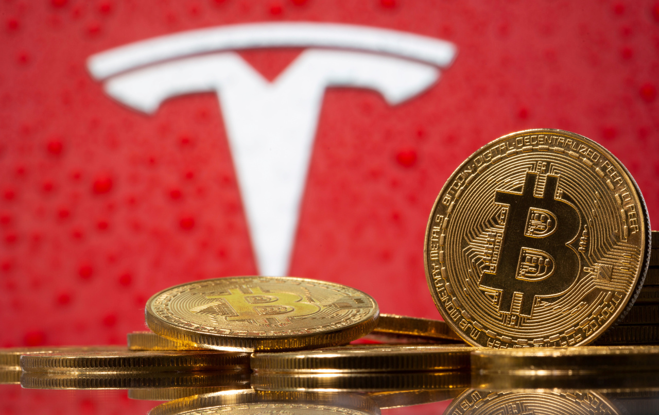 Representations of virtual currency Bitcoin are seen in front of Tesla logo in this illustration taken, February 9, 2021. (Reuters-Yonhap)