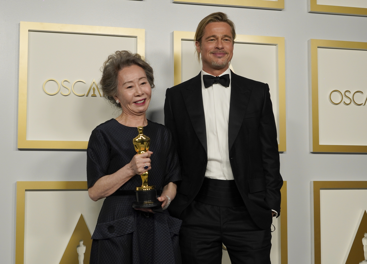 Brad Pitt, right, poses with Yuh-Jung Youn, winner of the award for best actress in a supporting role for 
