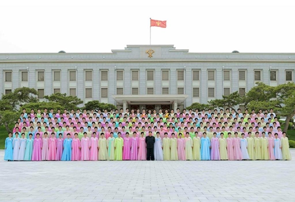 North Korean leader Kim Jong-un (C, 1st row) attends a group photo session with the art groups of servicemen's families from large combined units of the Korean People's Army (KPA) on Thursday, in this photo captured from the Rodong Sinmun the next day. (Rodong Sinmun)