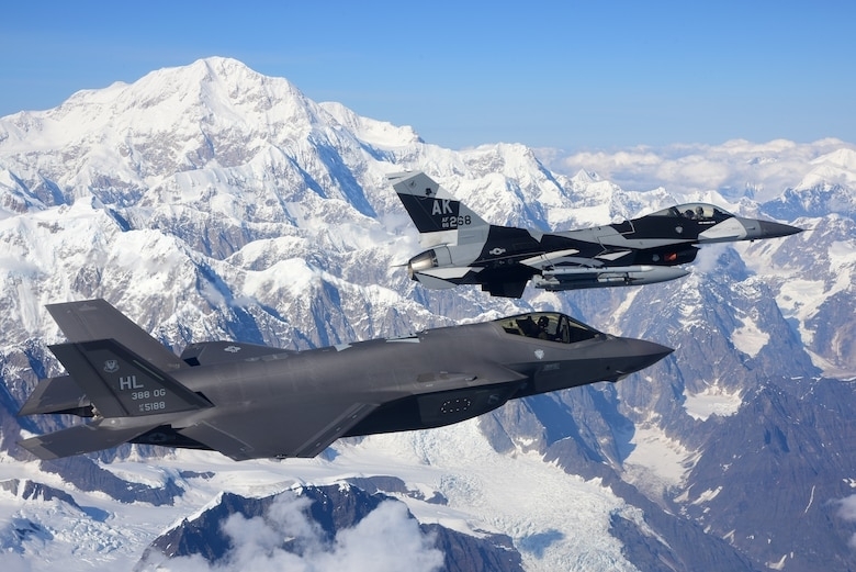 This photo downloaded from the US 7th Air Force website shows an F-35A Lightning II, assigned to the 388th Fighter Wing at Hill Air Force Base in Utah, and an F-16 Fighting Falcon, assigned to the 18th Aggressor Squadron at Eielson Air Force Base in Alaska, flying over Denali National Park, Alaska, on Aug. 17, 2020, during the Red Flag-Alaska 20-3 Training. (US 7th Air Force website)