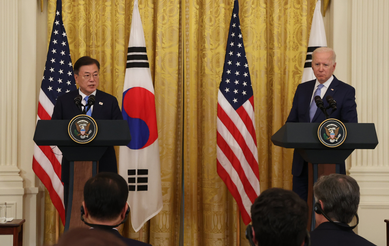 South Korean President Moon Jae-in (L) and US President Joe Biden hold a joint press conference following their talks at the White House in Washington on Friday. (Yonhap)