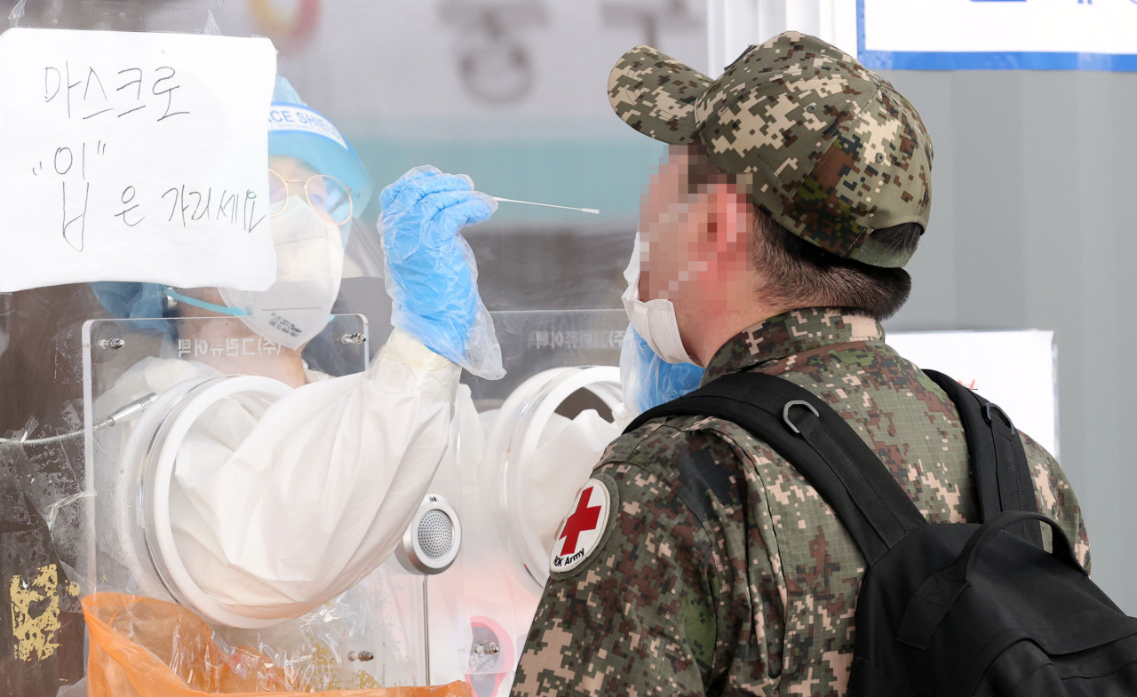 A solider receives a COVID-19 test at a makeshift clinic in central Seoul on Monday. (Yonhap)