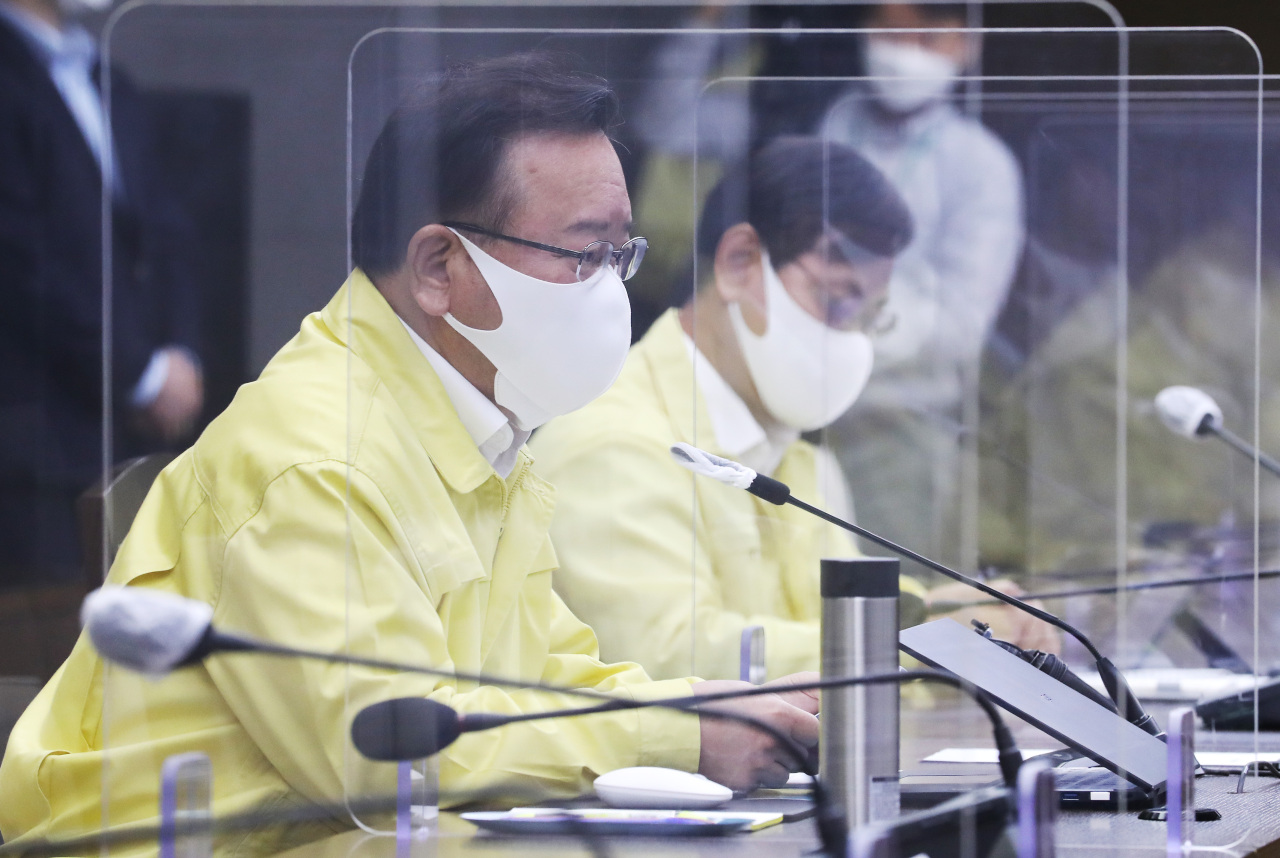 Prime Minister Kim Boo-kyum (L) speaks during a daily interagency meeting on the country's coronavirus response at the government complex in Sejong. (Yonhap)