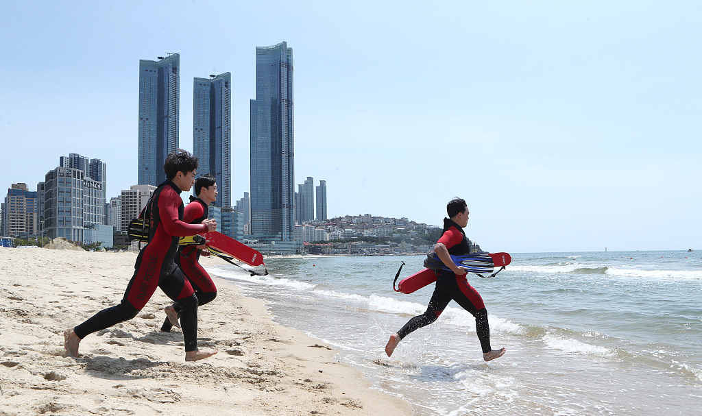 Lifeguards train at a beach in the southeastern port city of Busan on Tuesday. (Yonhap)