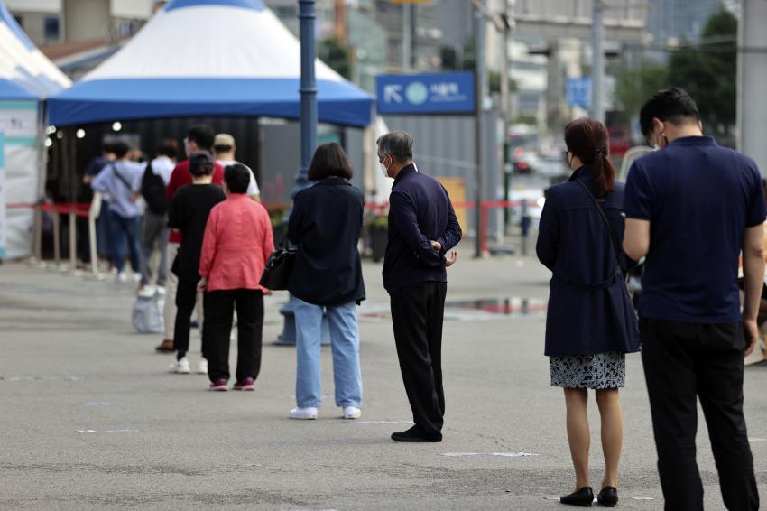 Citizens wait in line to receive virus tests at a makeshift virus testing clinic in Seoul on Wednesday. (Yonhap)