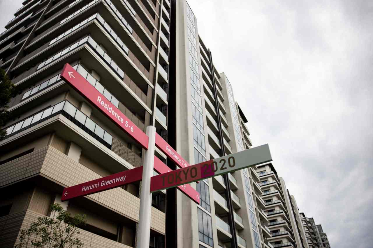 Residential buildings of the Olympic Village are seen behind road signs during a media tour of the Tokyo 2020 Olympic and Paralympic Village in Tokyo on Sunday (AFP-Yonhap)