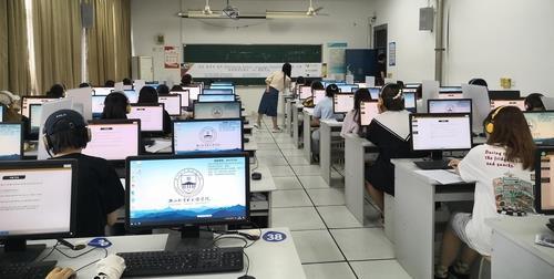 This photo, provided by the state-run King Sejong Institute Foundation, shows students taking a pilot version of the Sejong Korean Language Assessment test, which will be launched in 2022, at an education center in Hangzhou, China. (King Sejong Institute Foundation)