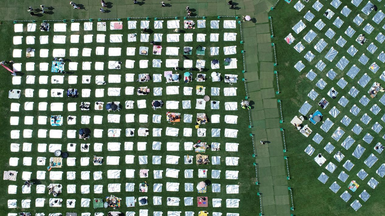 Citizens rest on picnic mats at the 