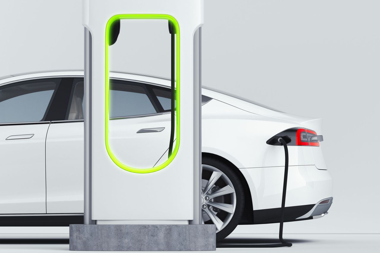 An electric vehicle is plugged in at a charging station (123rf)