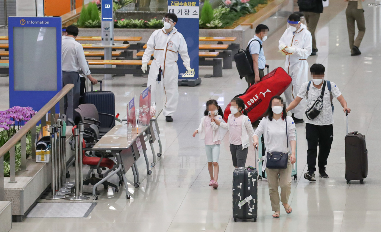 Travelers move about Incheon International Airport, west of Seoul, on Tuesday. (Yonhap)