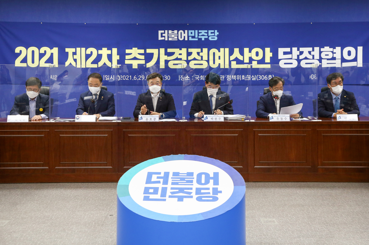The ruling Democratic Party lawmakers brief reporters on the second extra budget for this year at the National Assembly in western Seoul on Tuesday. (Yonhap)