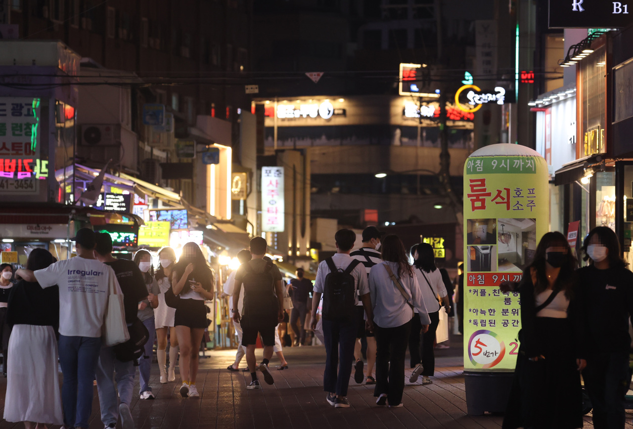 A street in Hongdae, one of the busiest entertainment districts in Seoul, is crowded with people on Tuesday. (Yonhap)