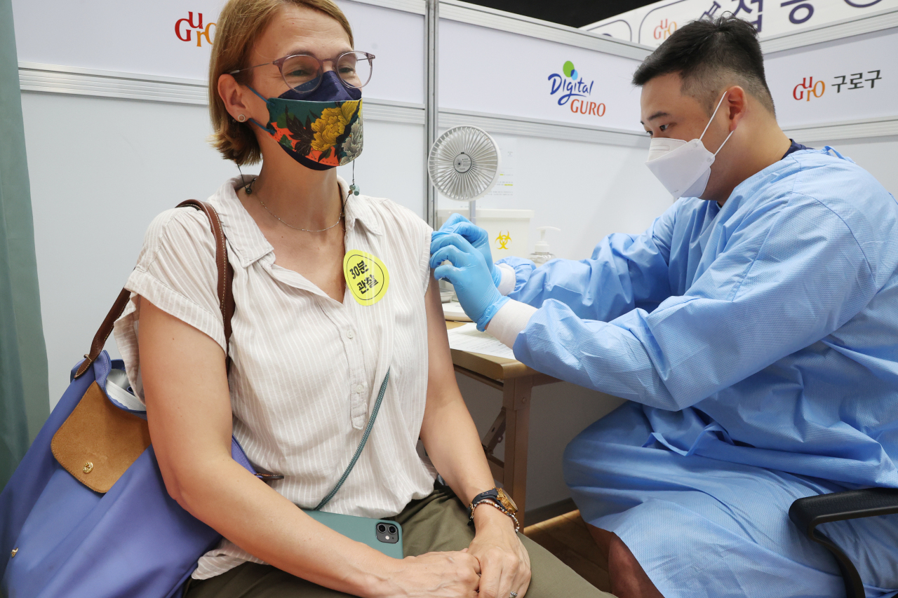 A teacher at an international school gets her COVID-19 shot at a clinic in Guro, southern Seoul, on Thursday. (Yonhap)