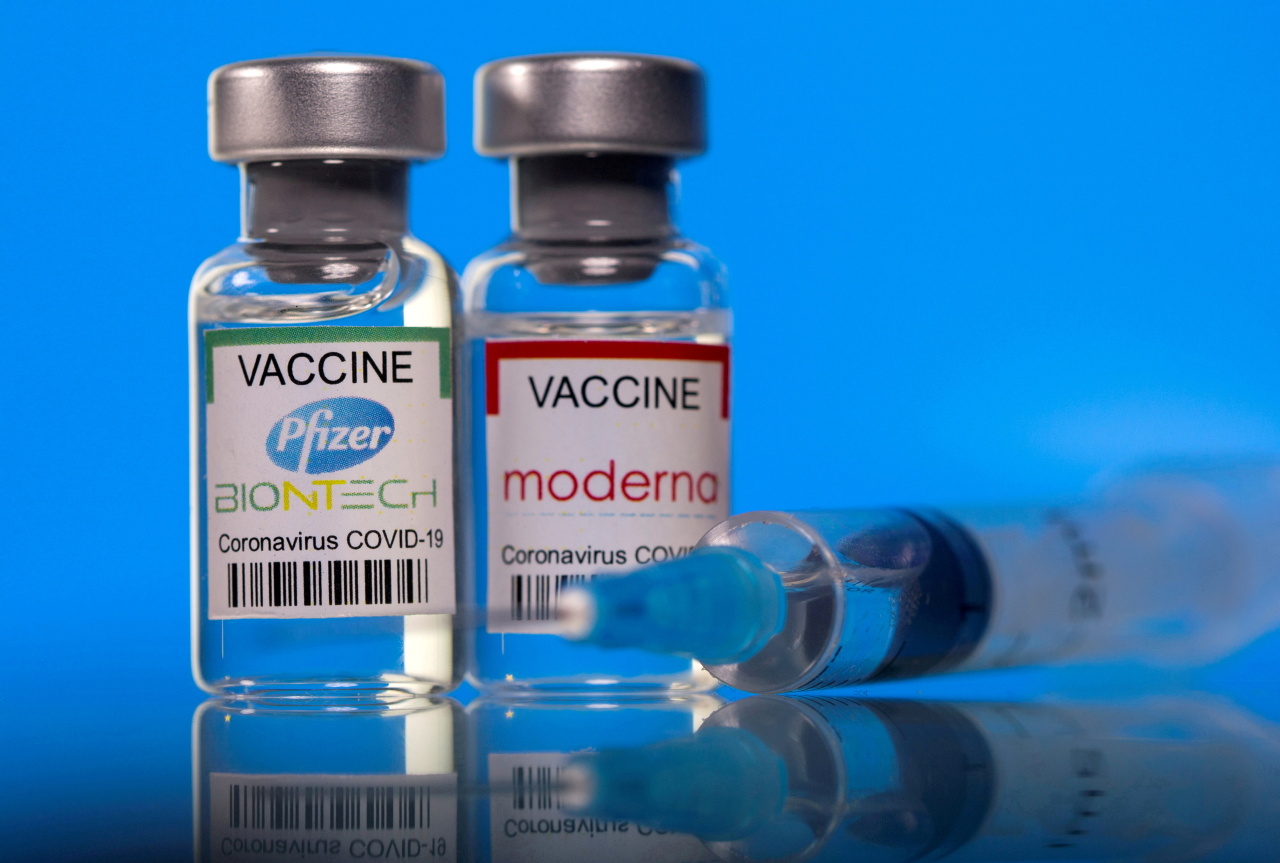 Vials with Pfizer-BioNTech and Moderna COVID-19 vaccine labels are seen in this illustration picture taken March 19. (Yonhap-Reuters)