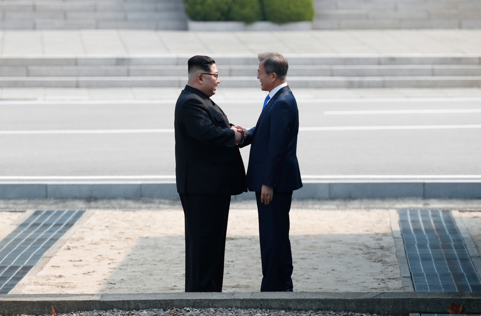 President Moon Jae-in and North Korean leader Kim Jong-un shake hands for their first summit at the border truce village of Panmunjeom in this file photo dated on April 27 2018. (Joint Press Corps)