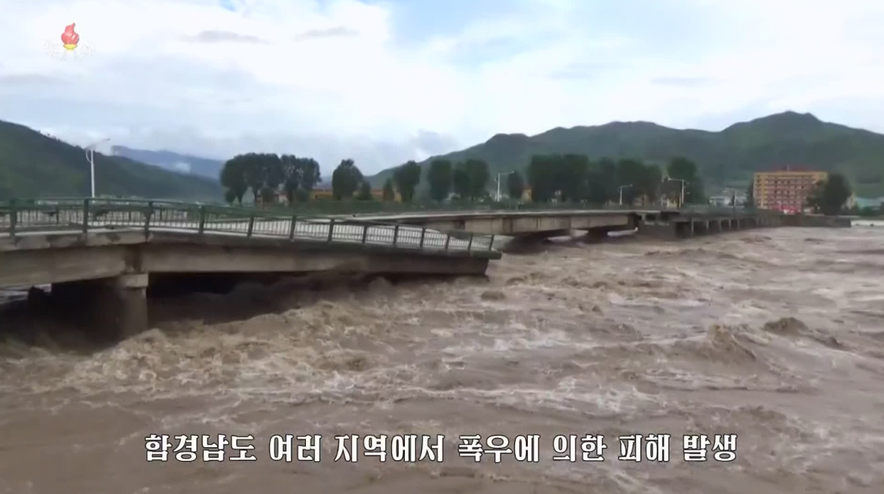 This captured image from the Korean Central Television on Thursday shows a bridge that was flooded and partly collapsed following heavy rains in North Korea's South Hamgyong Province. (Yonhap)