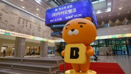 KakaoBank’s mascot stands in front of the Korea Exchange’s digital board Aug. 6, the day the mobile-only bank went public. (KakaoBank)