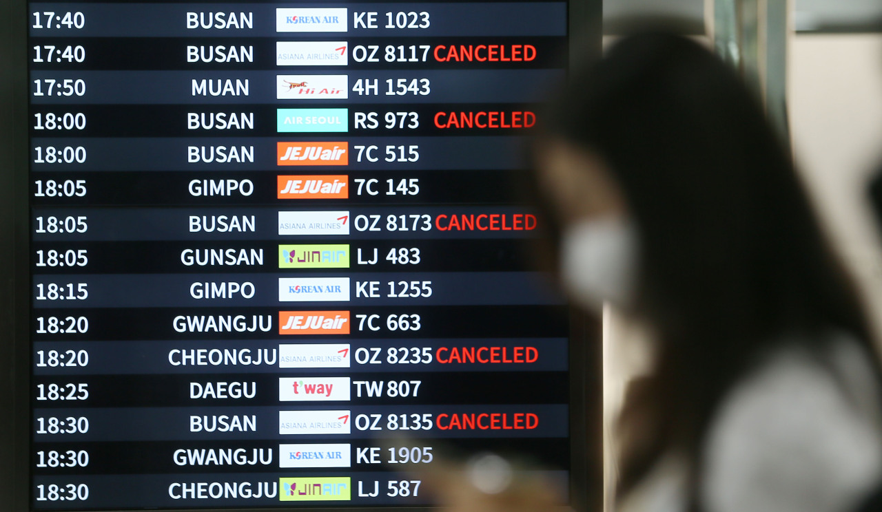 A departures board displays times of flights to and from Jeju, South Korea, affected by Typhoon Omais, Monday. (Yonhap)