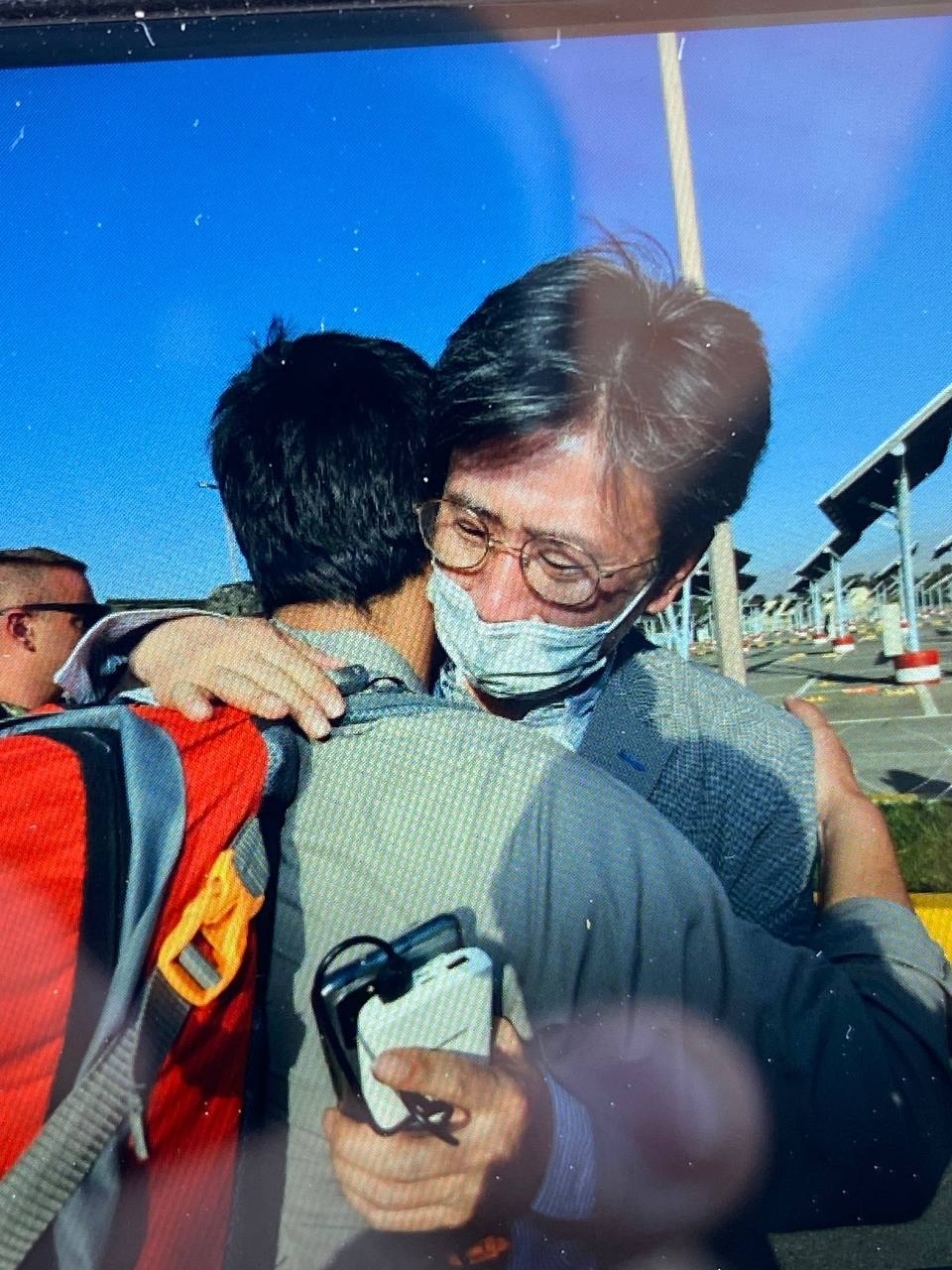 Minister Counselor Kim Il-eung of the South Korean Embassy in Kabul hugs an Afghan as he leads an evacuation mission, in this undated photo, released on Wednesday, by the foreign ministry. (Foreign Ministry)