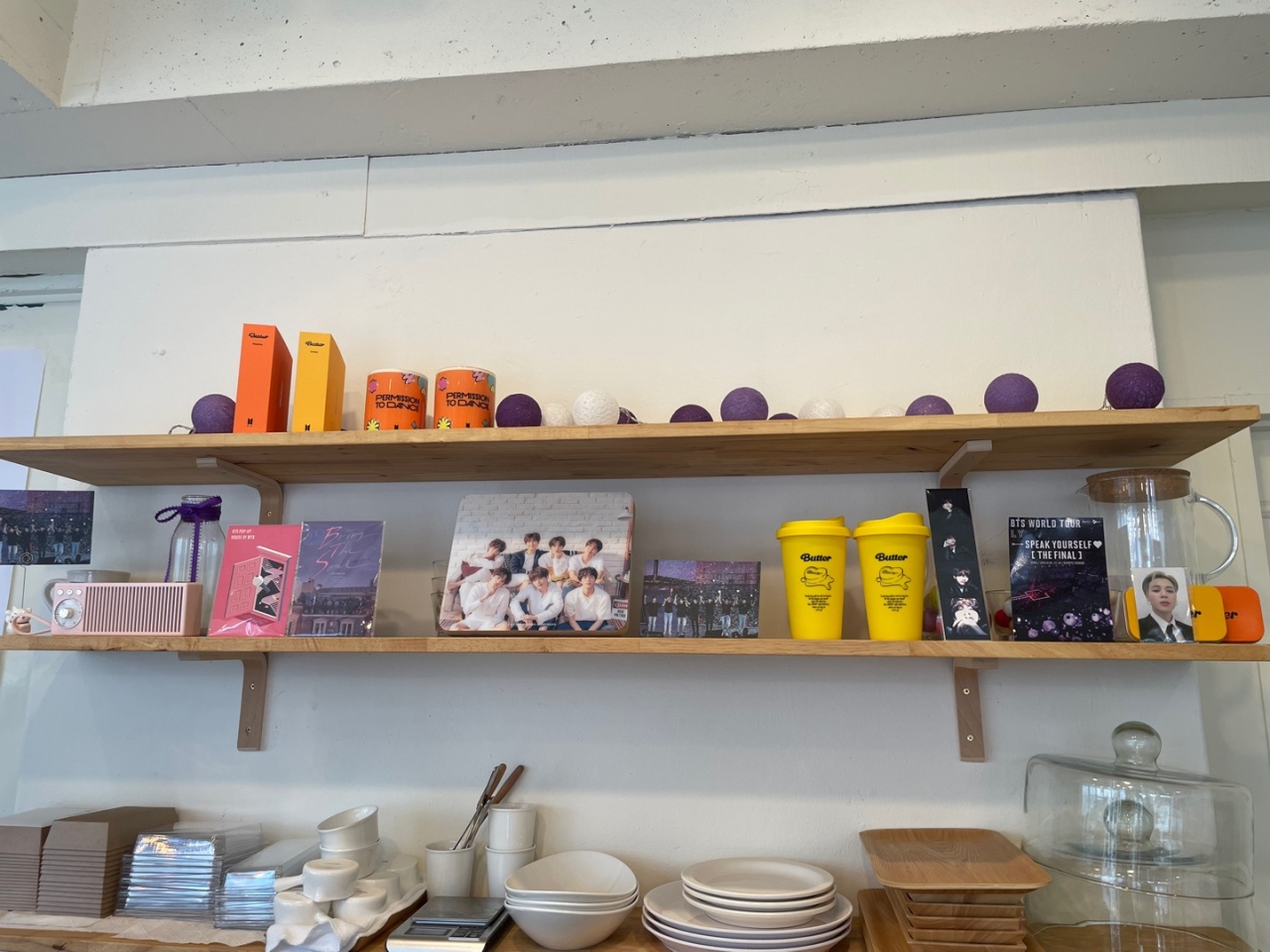 BTS merchandise and pictures are displayed on the shelf. (Kweon Ha-bin/The Korea Herald)