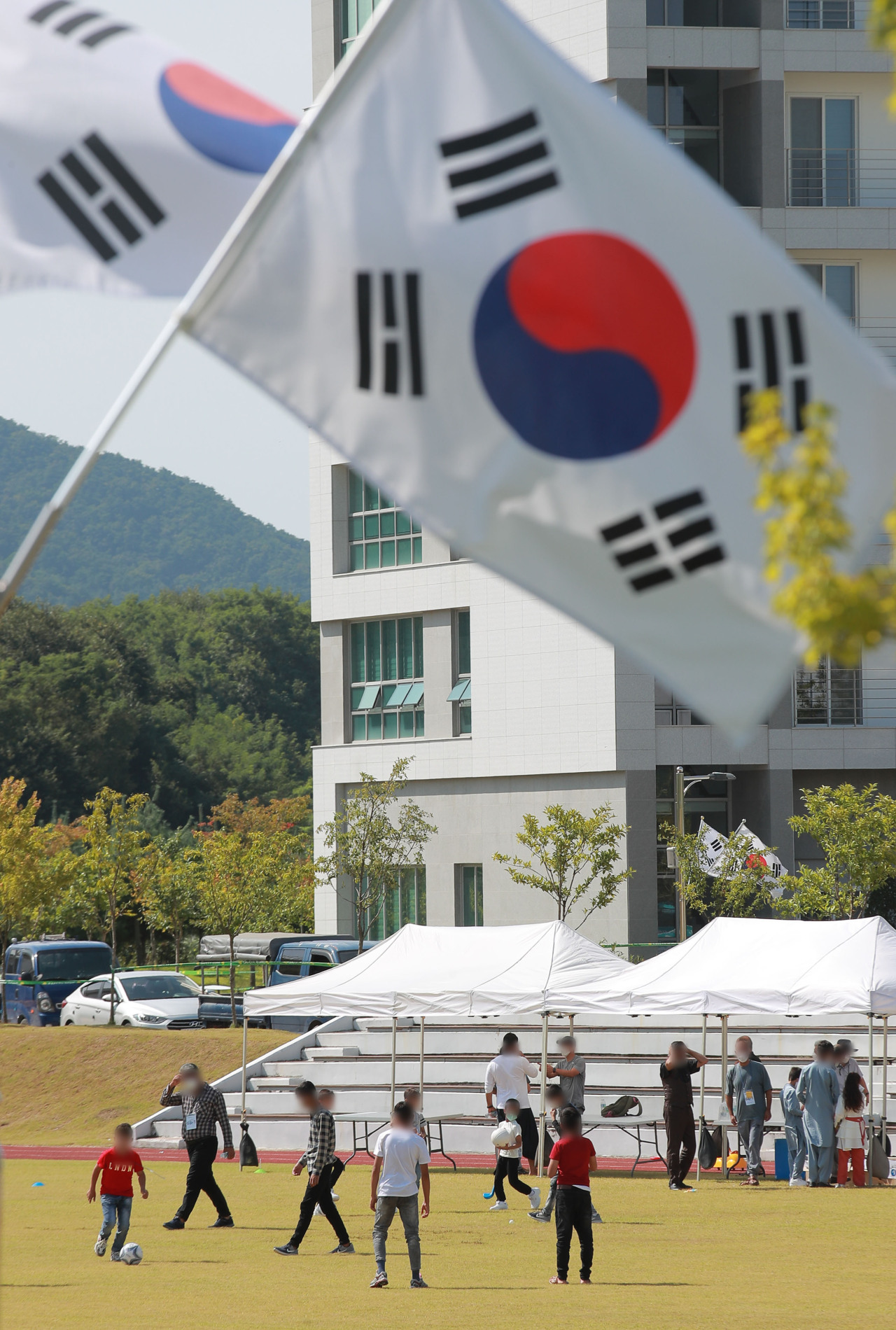 Afghan evacuees participate in outdoor activities at the National Human Resources Development Institute in Jincheon, North Chungcheong Province, on Sept. 13 after completing a mandatory two-week self-quarantine upon arriving in Korea. (Yonhap)