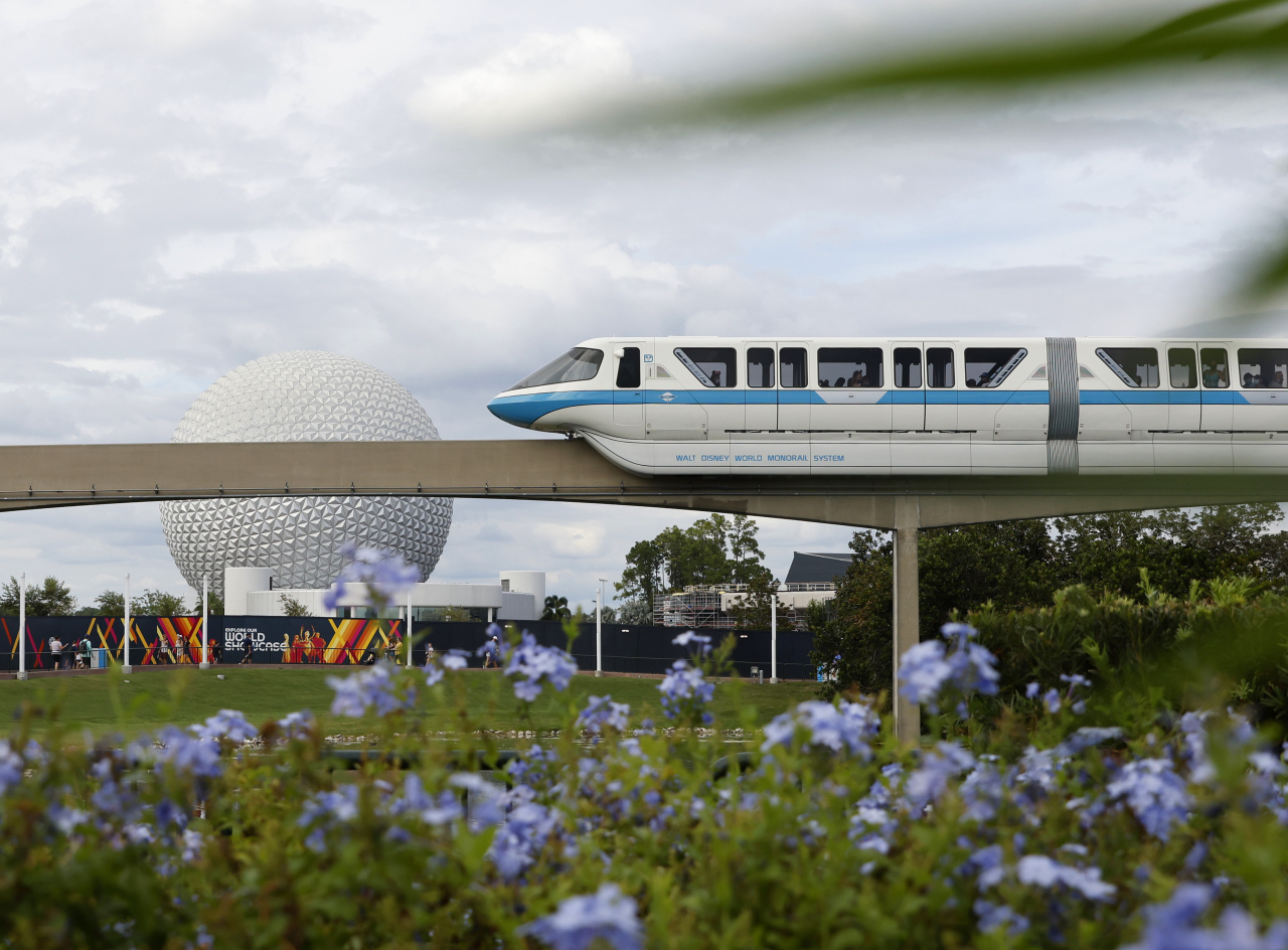 The Walt Disney World Monorail System passes by Spaceship Earth.
