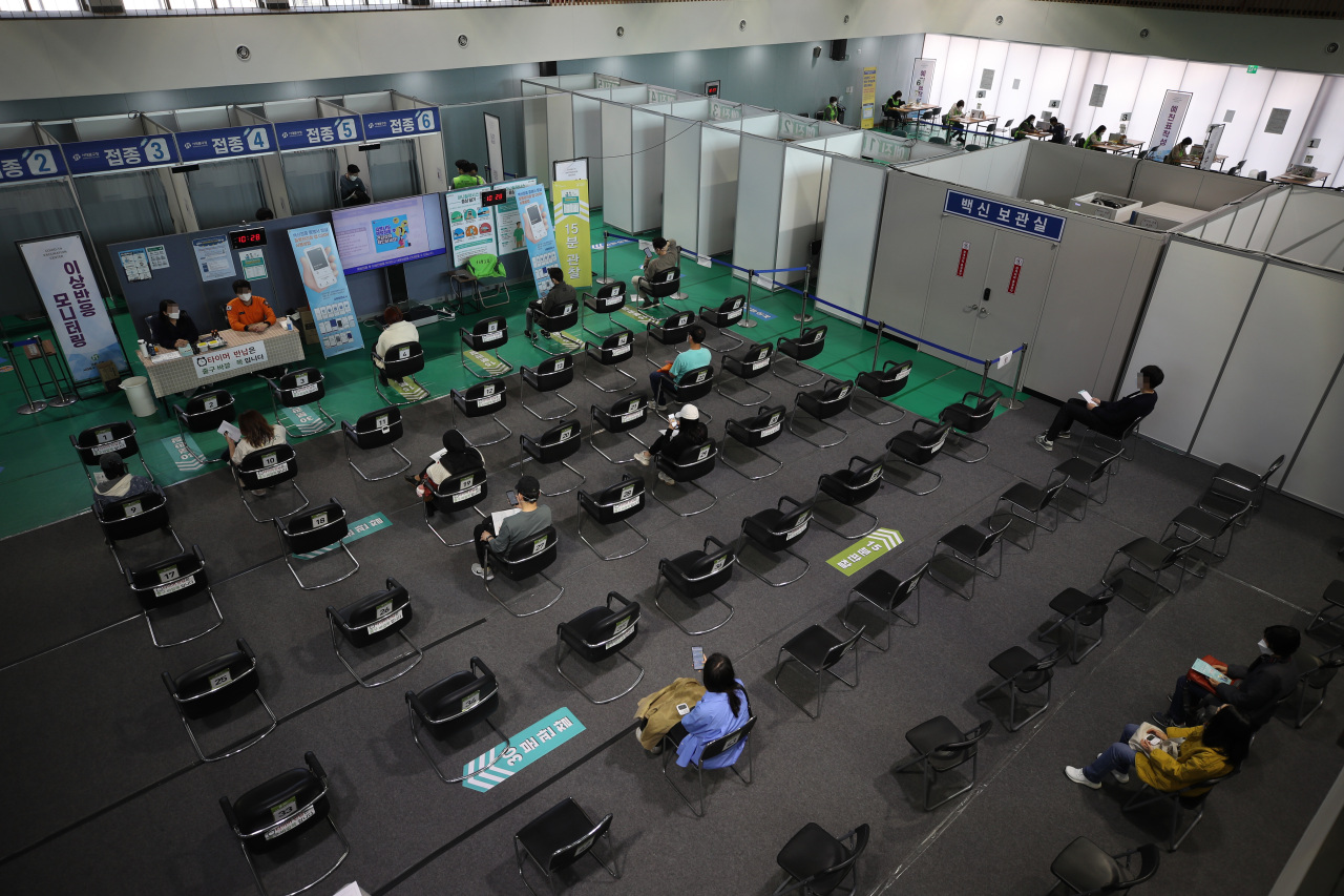 People wait to monitor for side effects after getting vaccinated at an inoculation center in Seoul on Friday. (Yonhap)