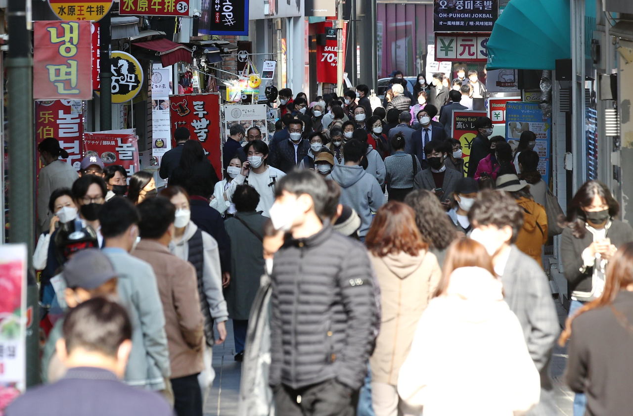 This photo, taken on Monday shows people at the shopping district of Myeongdong in downtown Seoul as South Korea plans to gradually return to normal life starting next month with eased virus restrictions. (Yonhap)