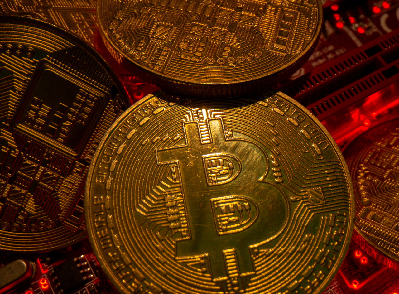 Representations of the virtual currency bitcoin stand on a motherboard in this picture illustration taken May 20. (Reuters-Yonhap)