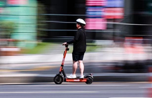 A person rides an e-scooter. (Yonhap)