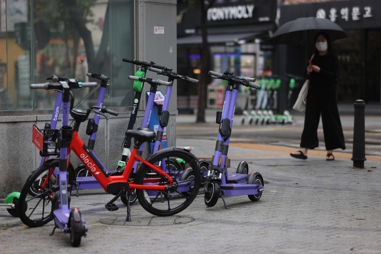 Electric scooters are parked by an entrance of a subway station in Seodaemun-gu, western Seoul, on July 7, 2021. (Yonhap)