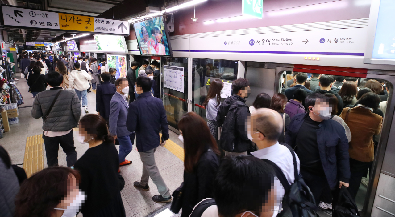 A subway stop for Seoul Station is busy with commuters in the morning on Monday, the first day South Korea's 