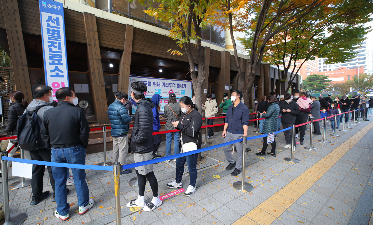 Seoul citizens wait in line to get tested for the coronavirus at a testing center in eastern Seoul on Thursday. (Yonhap)
